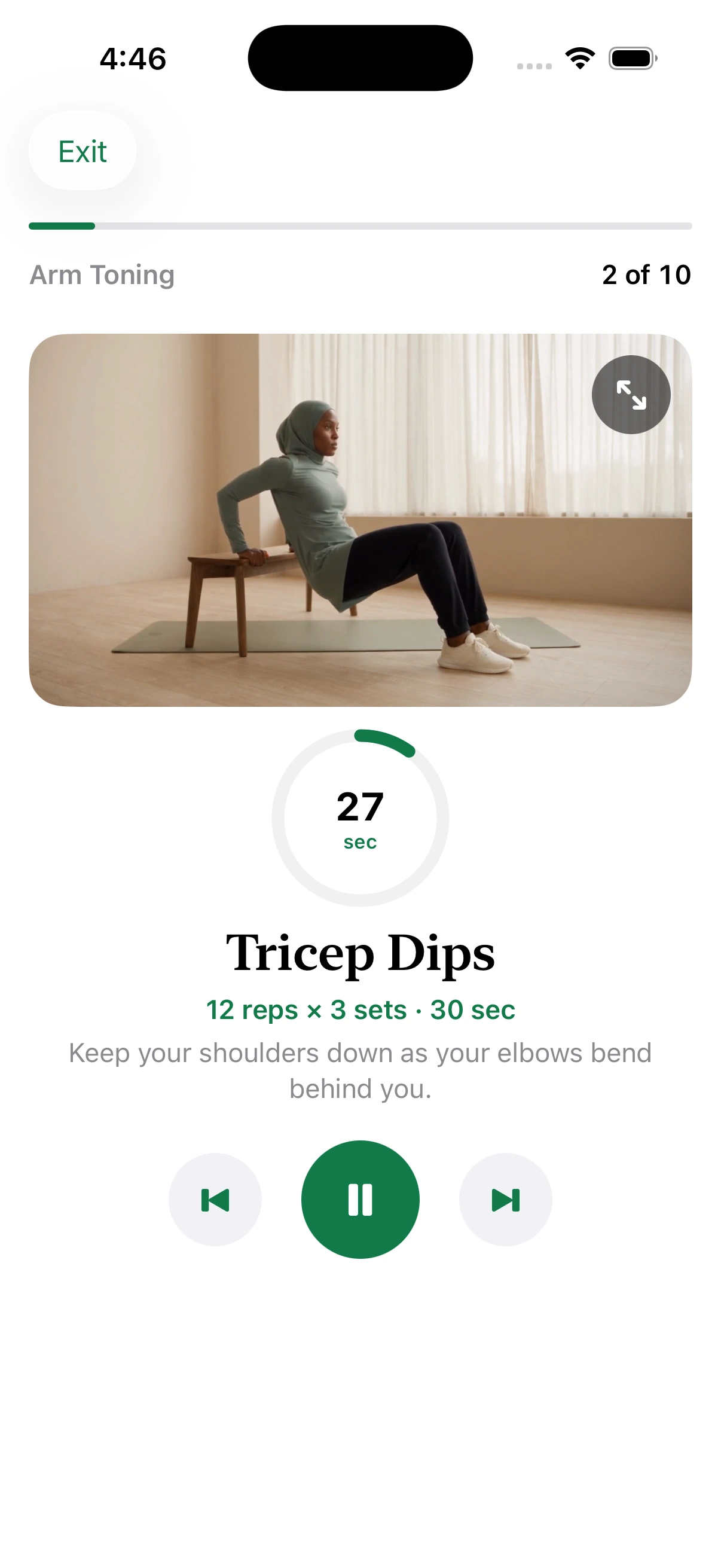 Muslima Fit guided workout screen showing a coach demonstrating tricep dips with a timer and playback controls